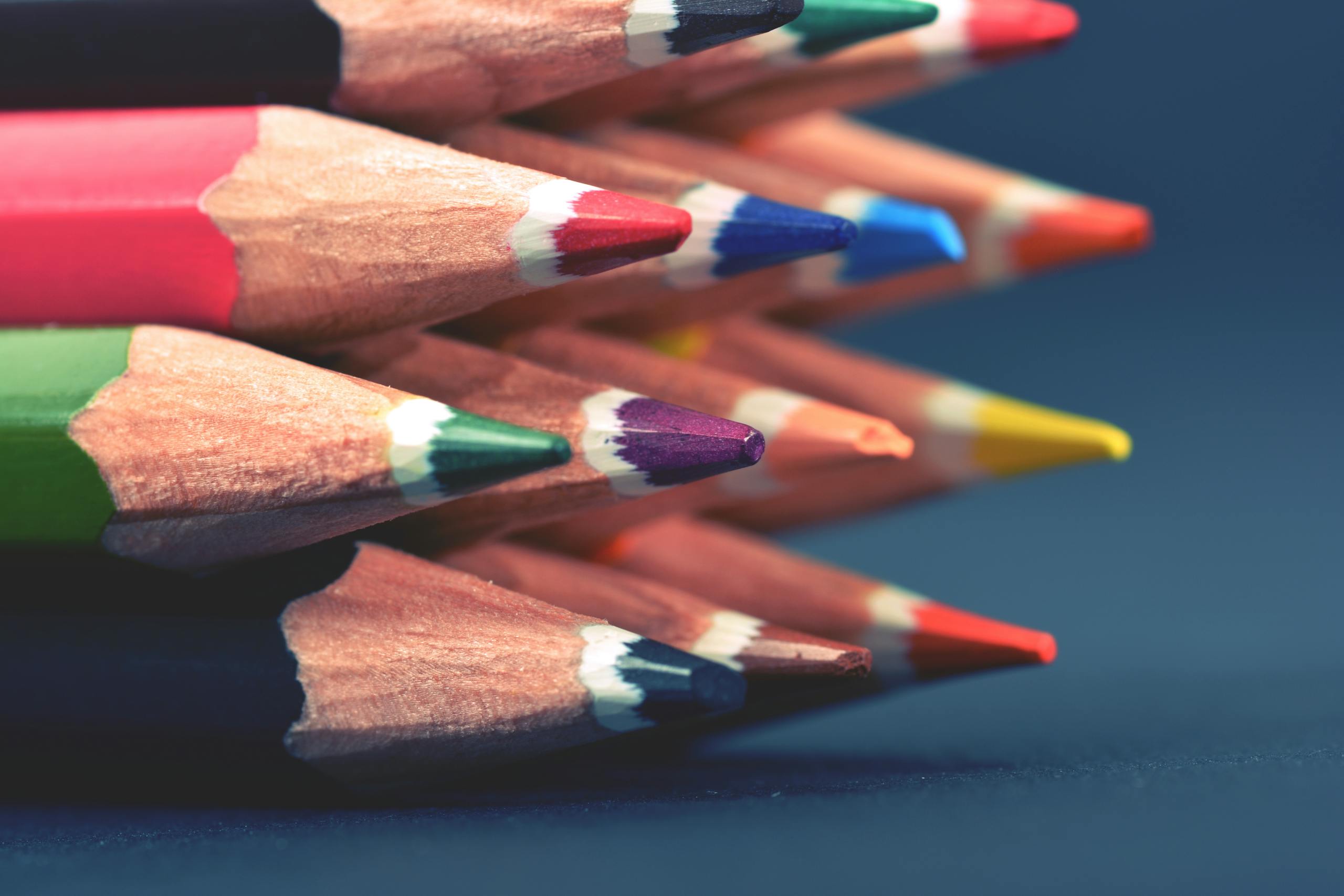 Close-up of stacked colored pencils showcasing vibrant colors for art and creativity.