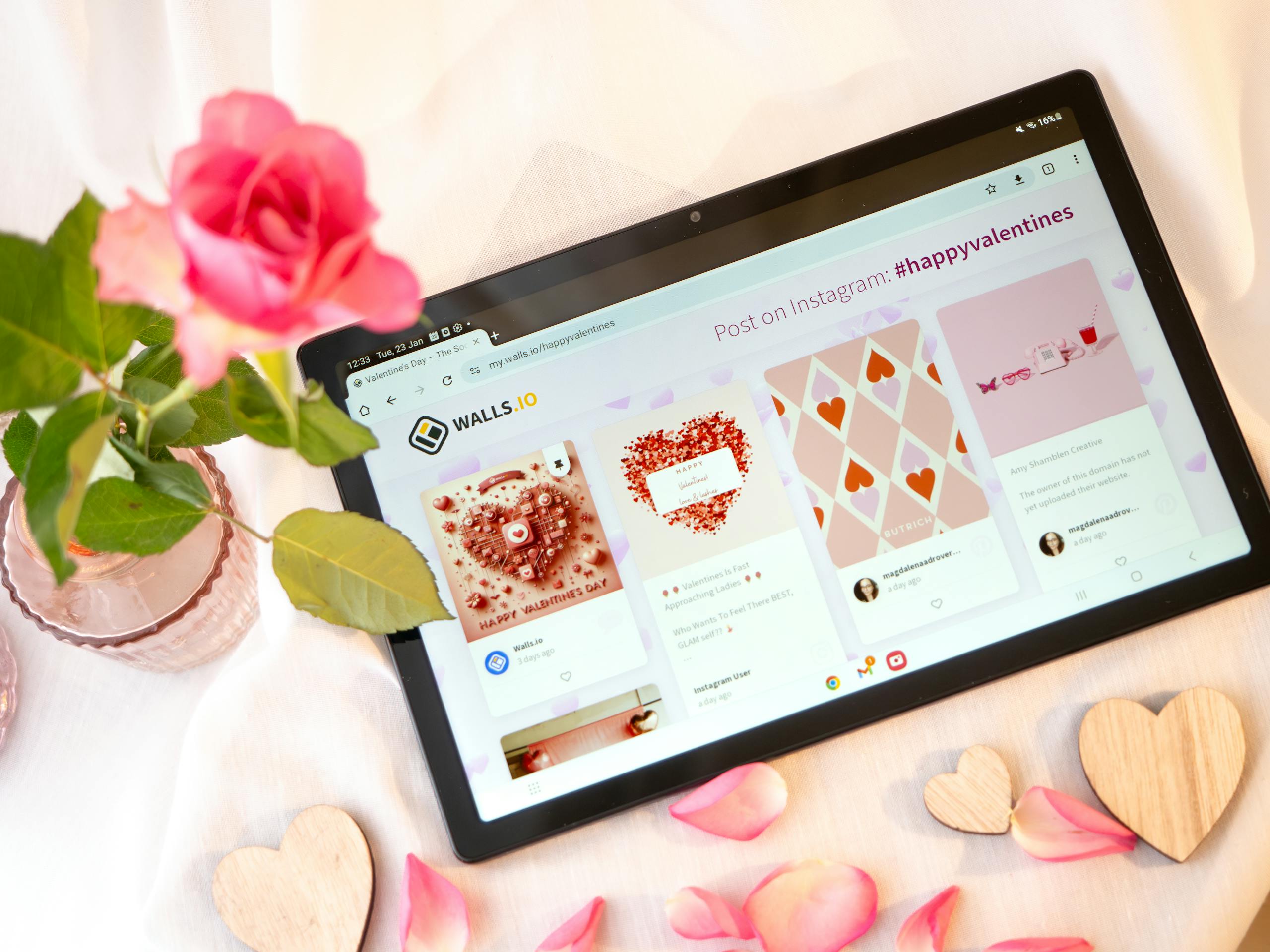 Valentine's Day-themed tablet display with rose and wooden hearts, creating a romantic ambiance.